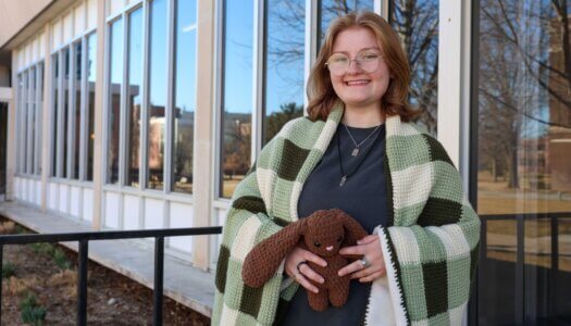 UNK junior Gabby Klein poses for a photo with some of her crochet creations.