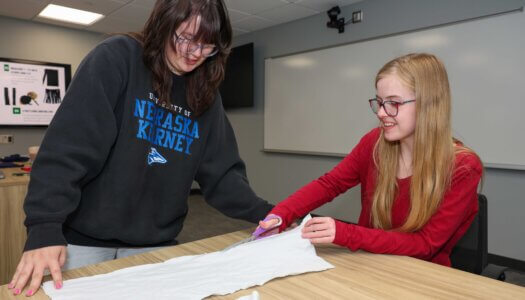 Crochet Circle members Julia McKlem and Katy Lovejoy work on a project during a recent meeting.