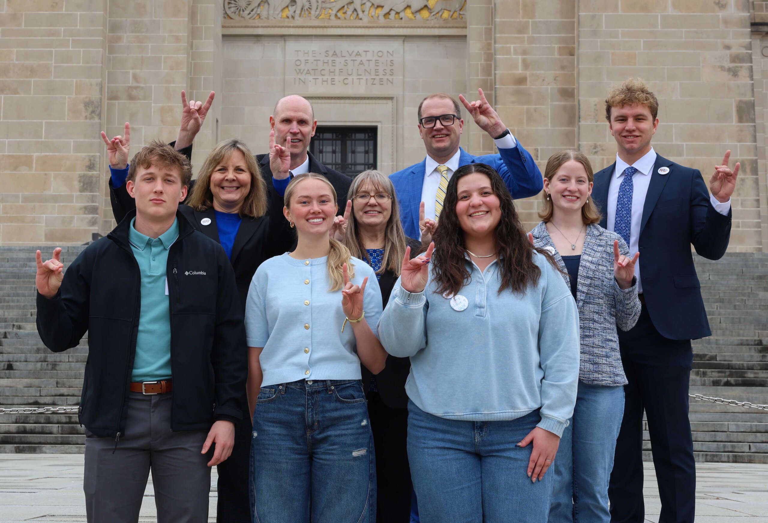 UNK students and administrators pose for a photo outside the State Capitol.