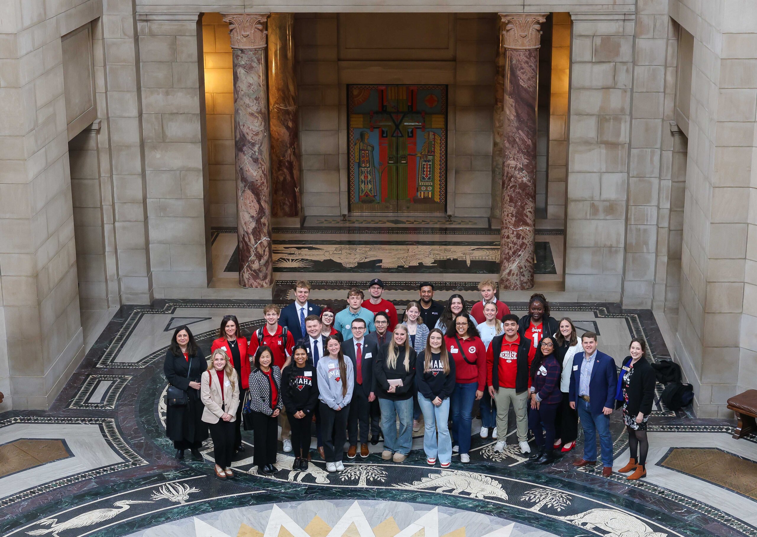 University of Nebraska supporters pose for a photo in the State Capitol Rotunda during "I Love NU" Day.