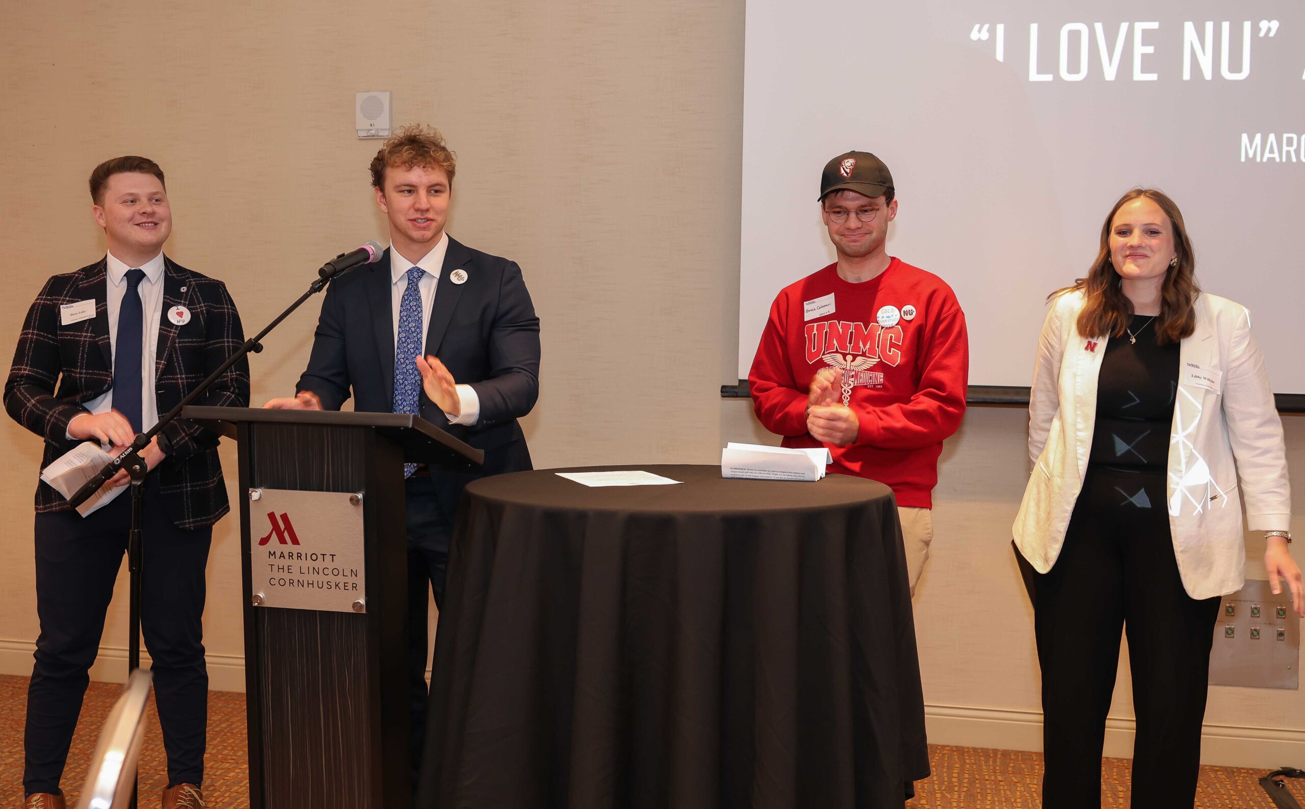 UNK senior Sam Schroeder, at the podium, speaks Wednesday during the annual “I Love NU” Day celebration in Lincoln. He’s pictured with student regents from the other University of Nebraska campuses.