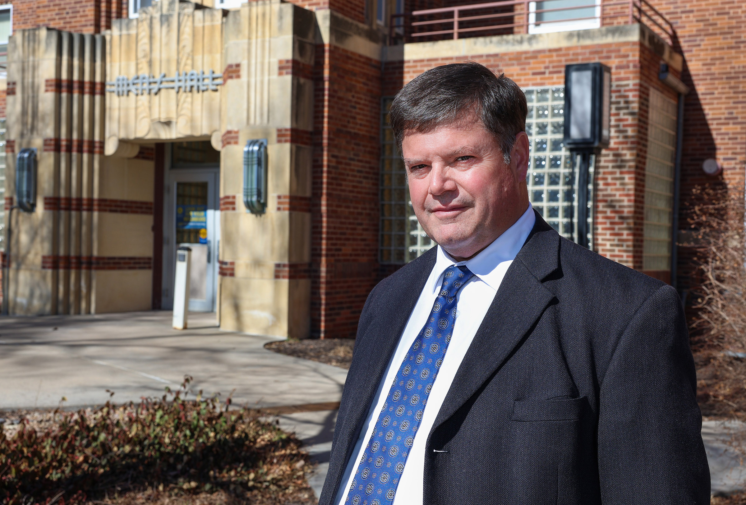 John Falconer poses for a photo outside Men's Hall on the UNK campus.