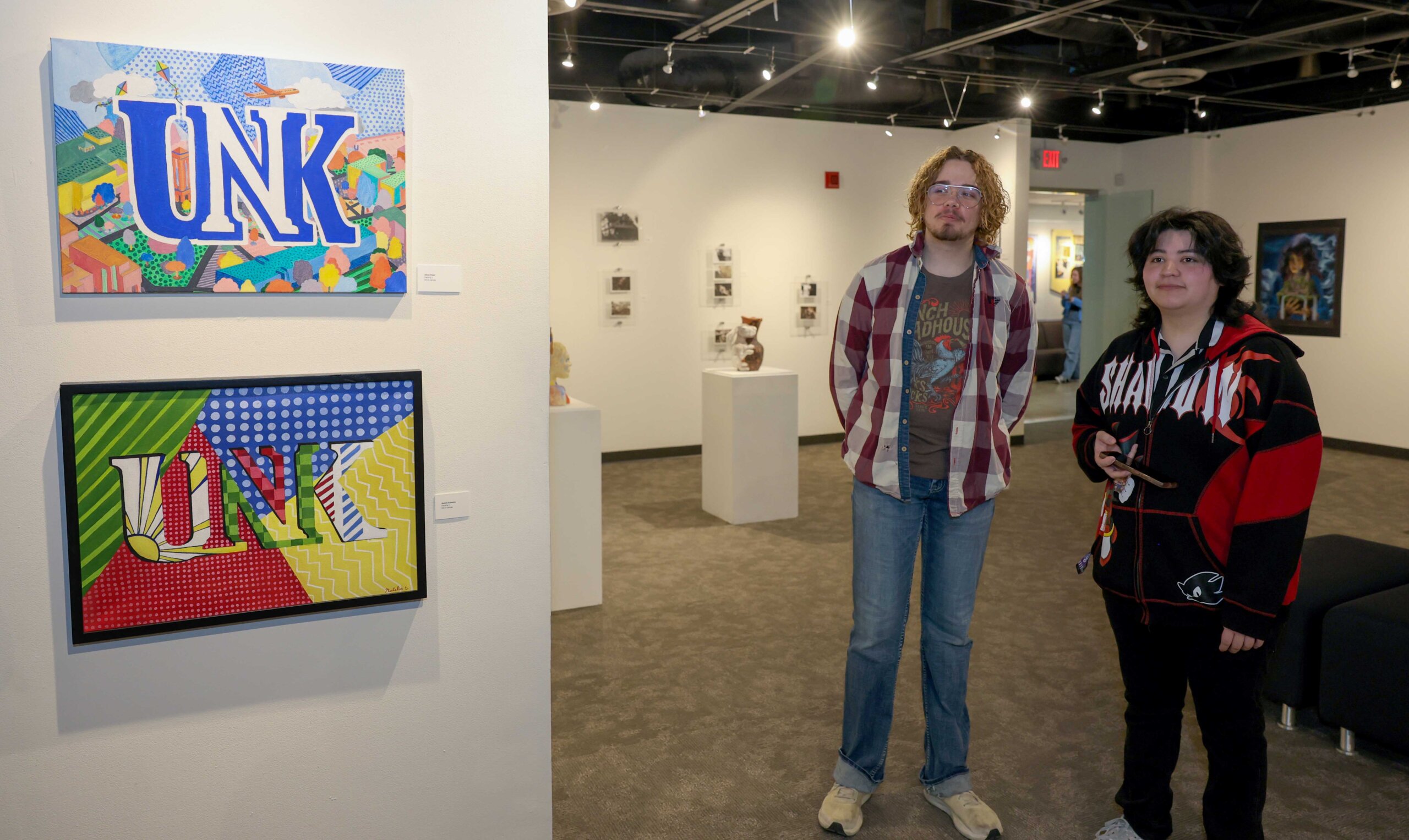 Paintings of UNK logos hang on the wall at Walker Art Gallery.