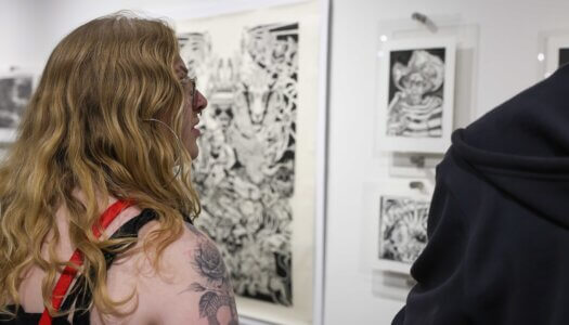 Attendees check out the Faculty Select Exhibit during Thursday's reception.