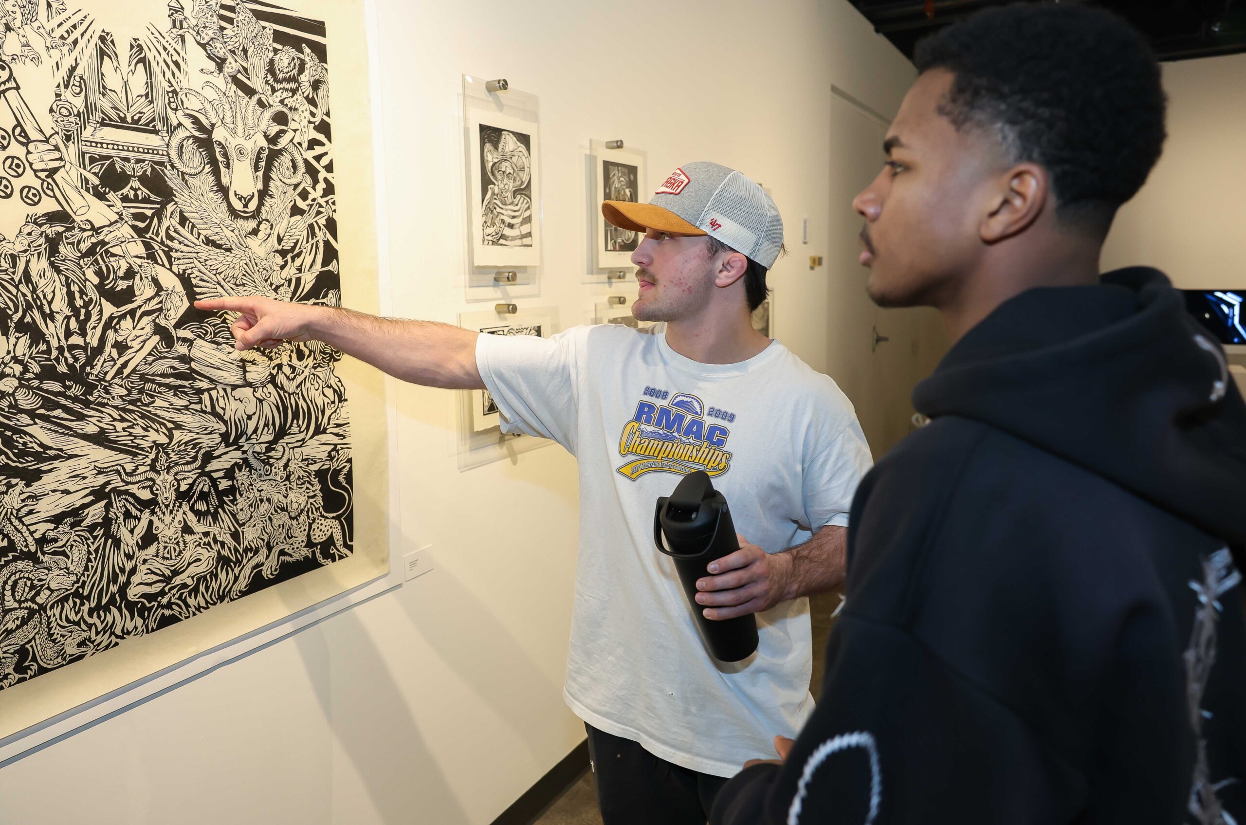 UNK students look at a project on display at Walker Art Gallery.