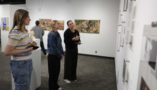 UNK students check out the pieces on display at Walker Art Gallery.