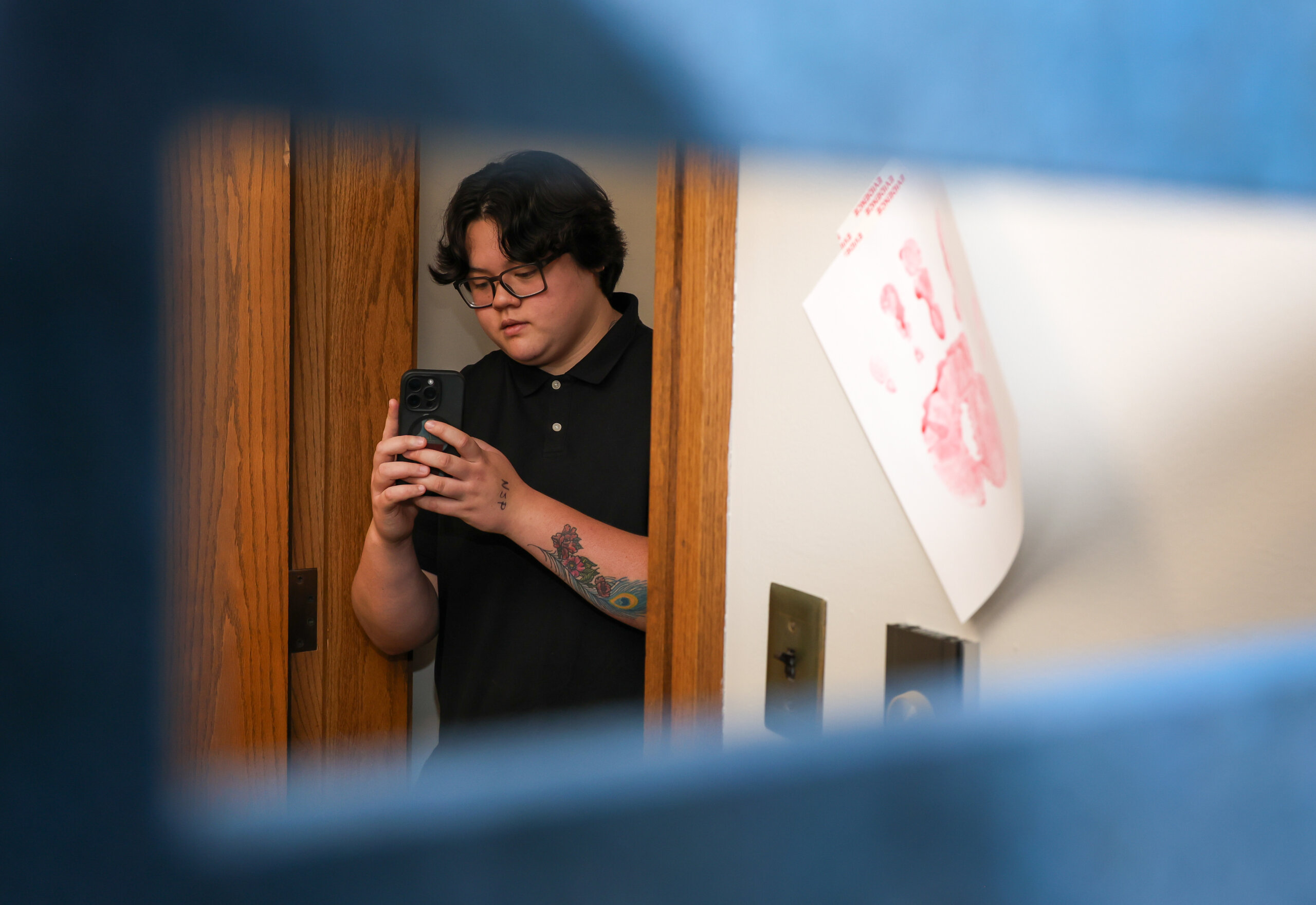 A student takes photos in a staged crime scene.