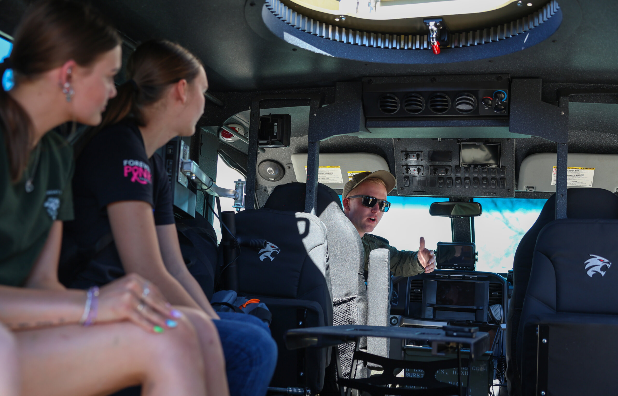 Students sit in a NSP vehicle.