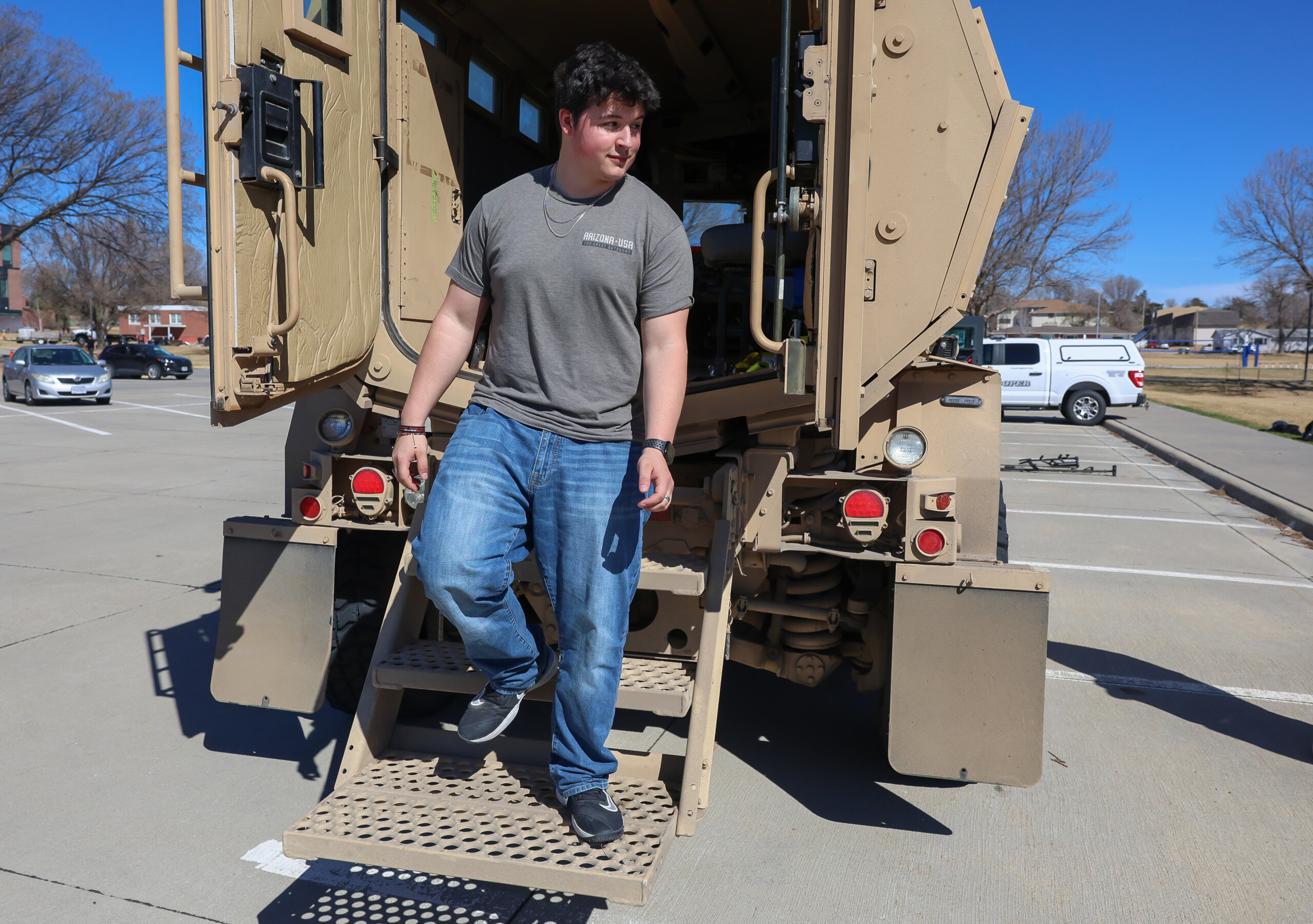 A student steps out of an NSP vehicle.