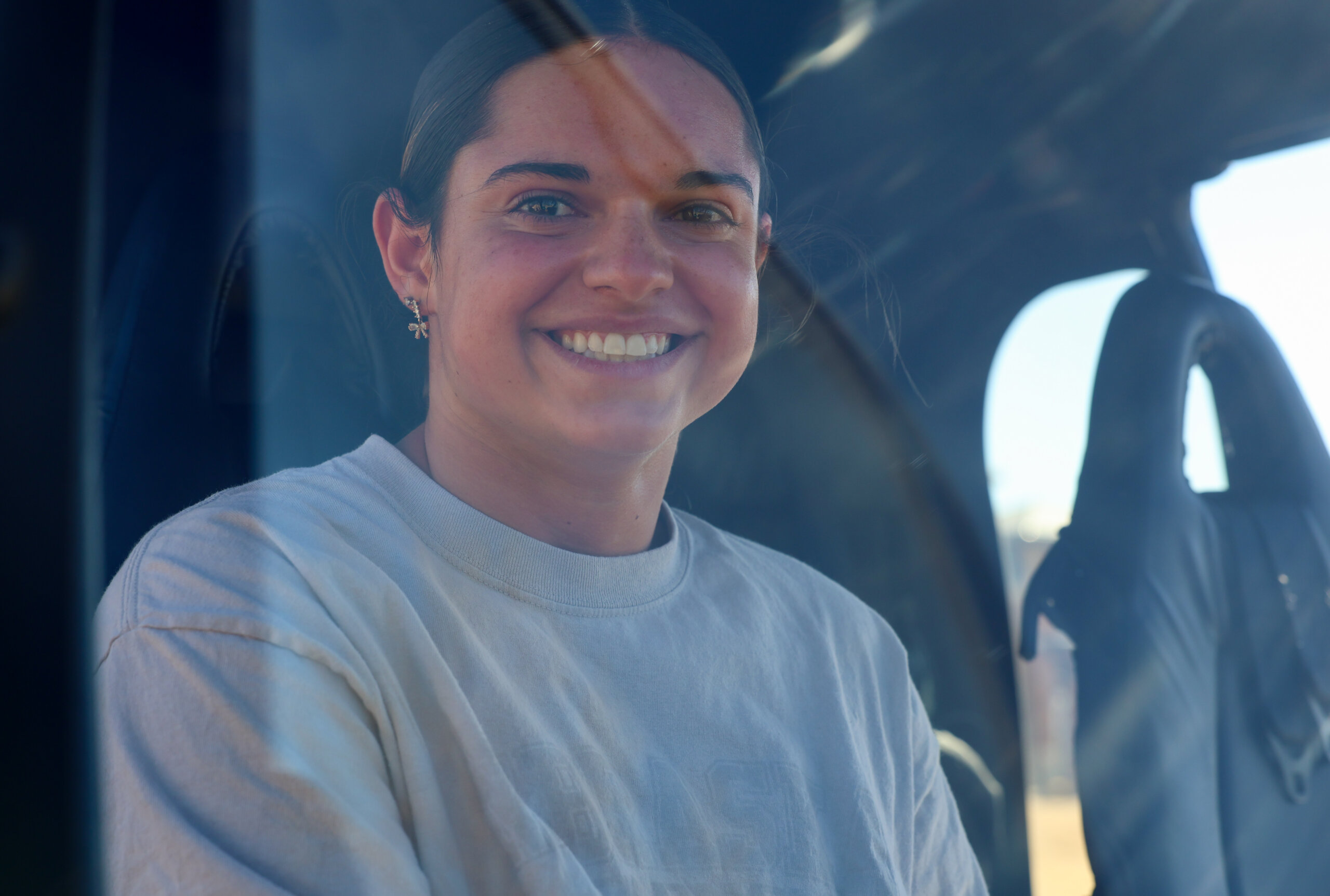 A student sits inside a helicopter.