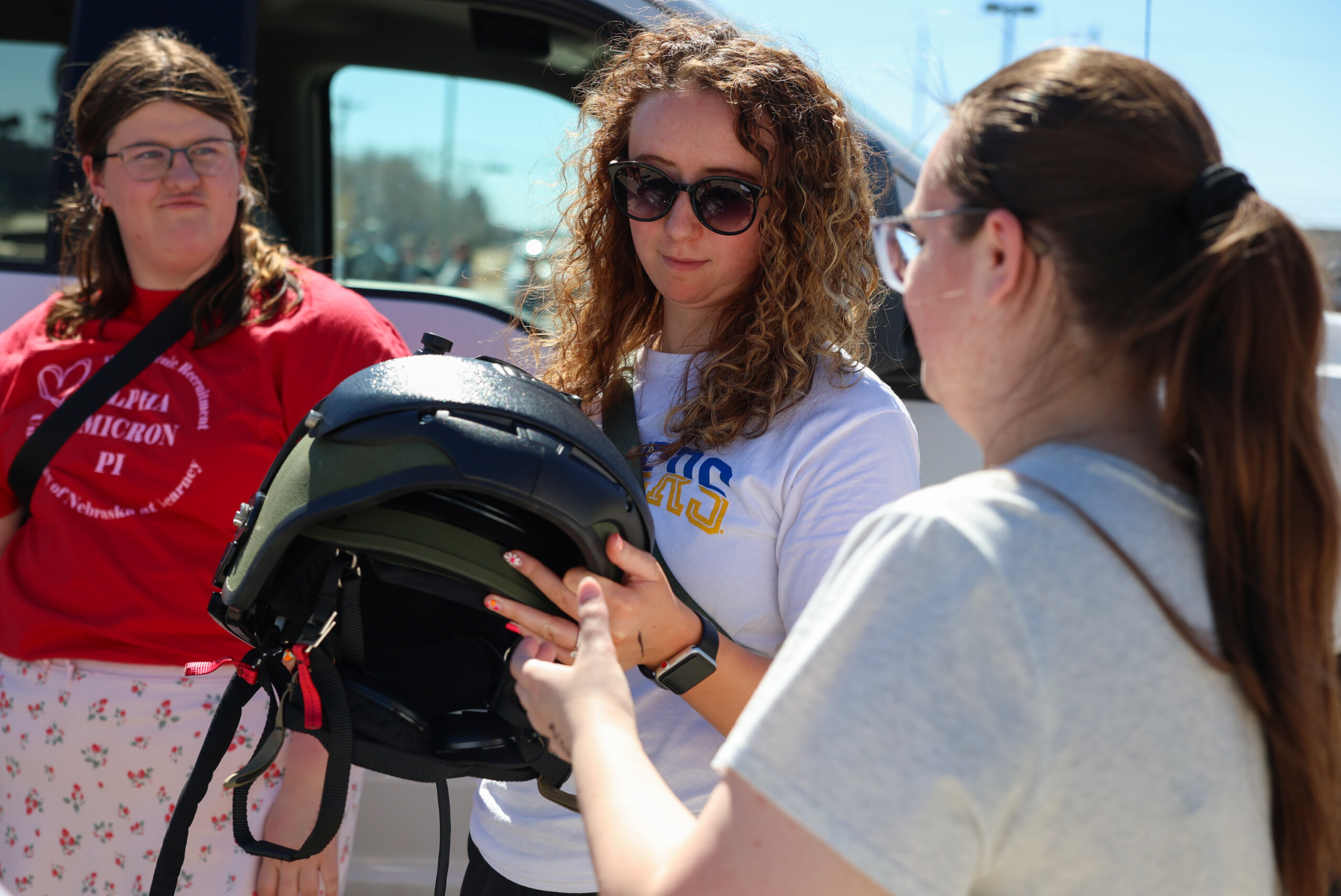 Students hold NSP bomb squad gear.