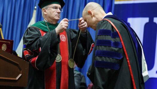 University of Nebraska System President Dr. Jeffrey Gold presents Neal Schnoor with the Chancellor's Medallion.