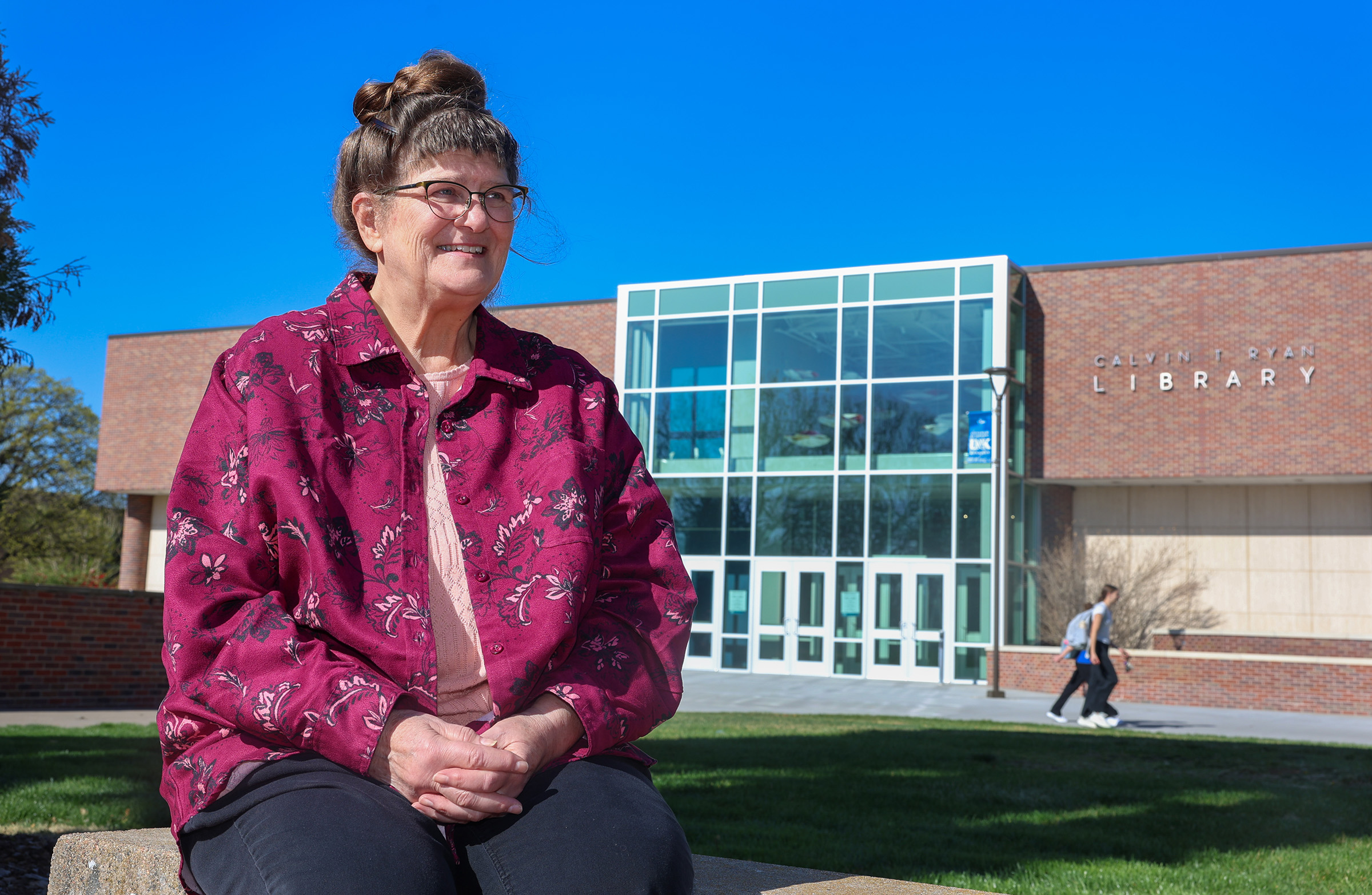 Alta Kramer poses for a photo outside Calvin T. Ryan Library.