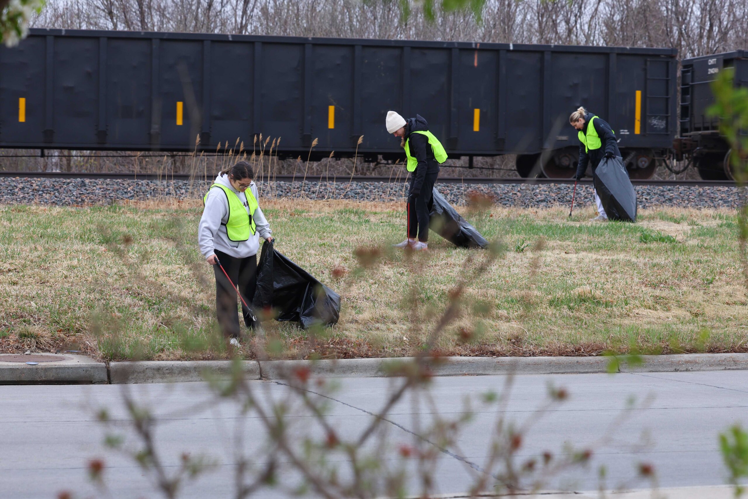 Graduate students in the UNK school psychology program clean up trash along Railroad Street in Kearney during The Big Event.