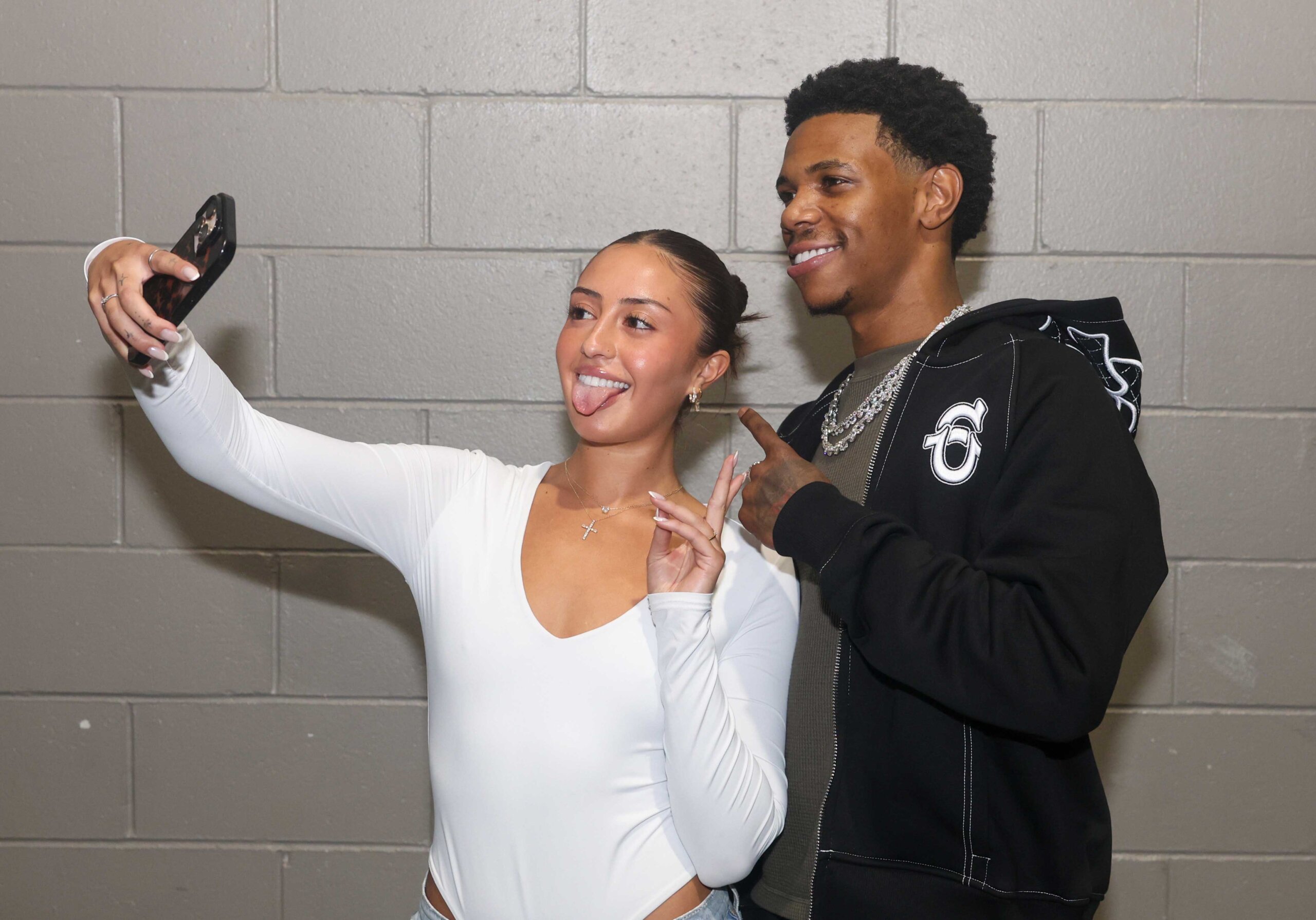 A Boogie Wit da Hoodie poses for a photo with a fan.