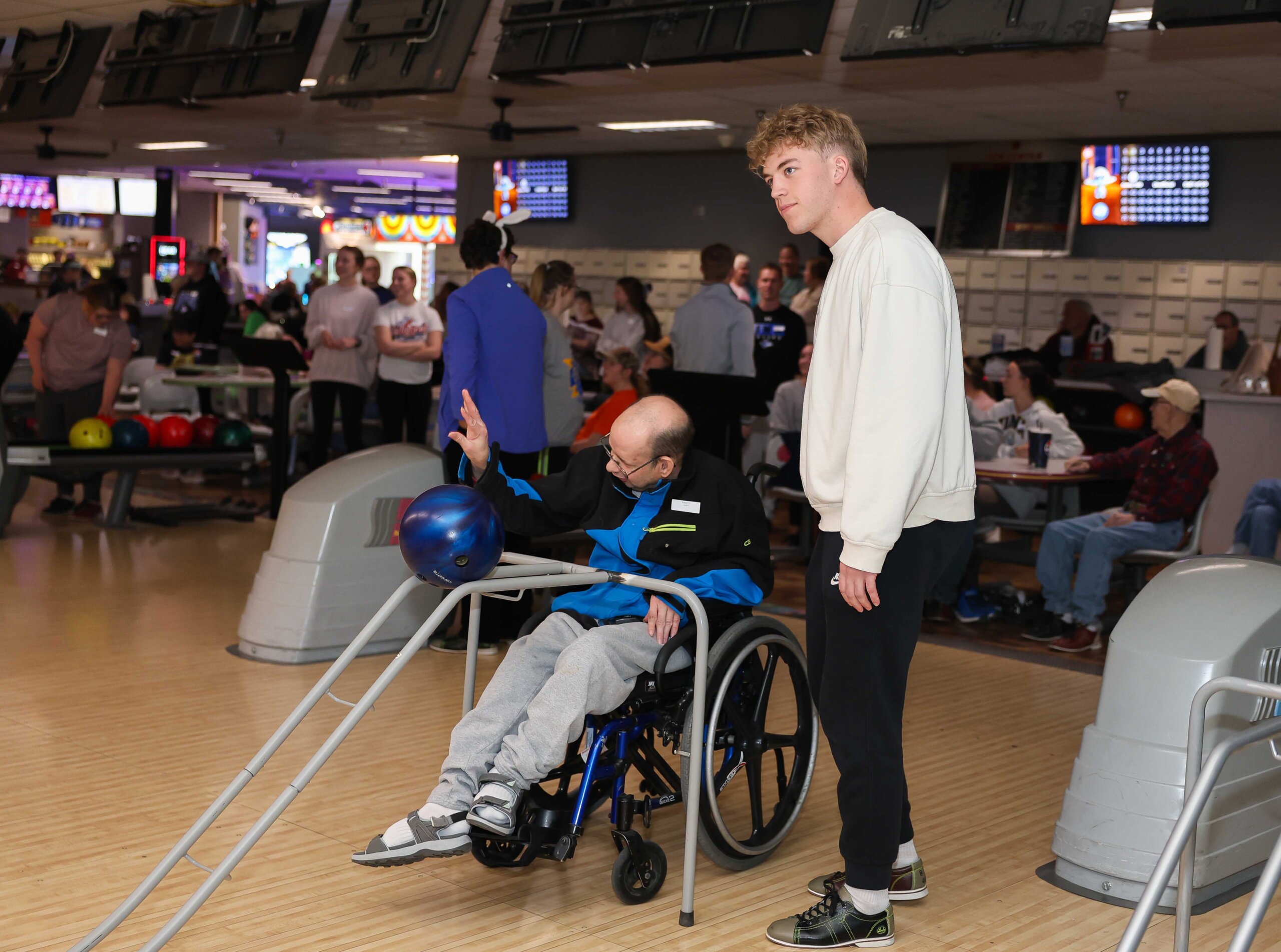 UNK sophomore Evan Kiene assists during the Buddy Bowling program at Big Apple Fun Center in Kearney.