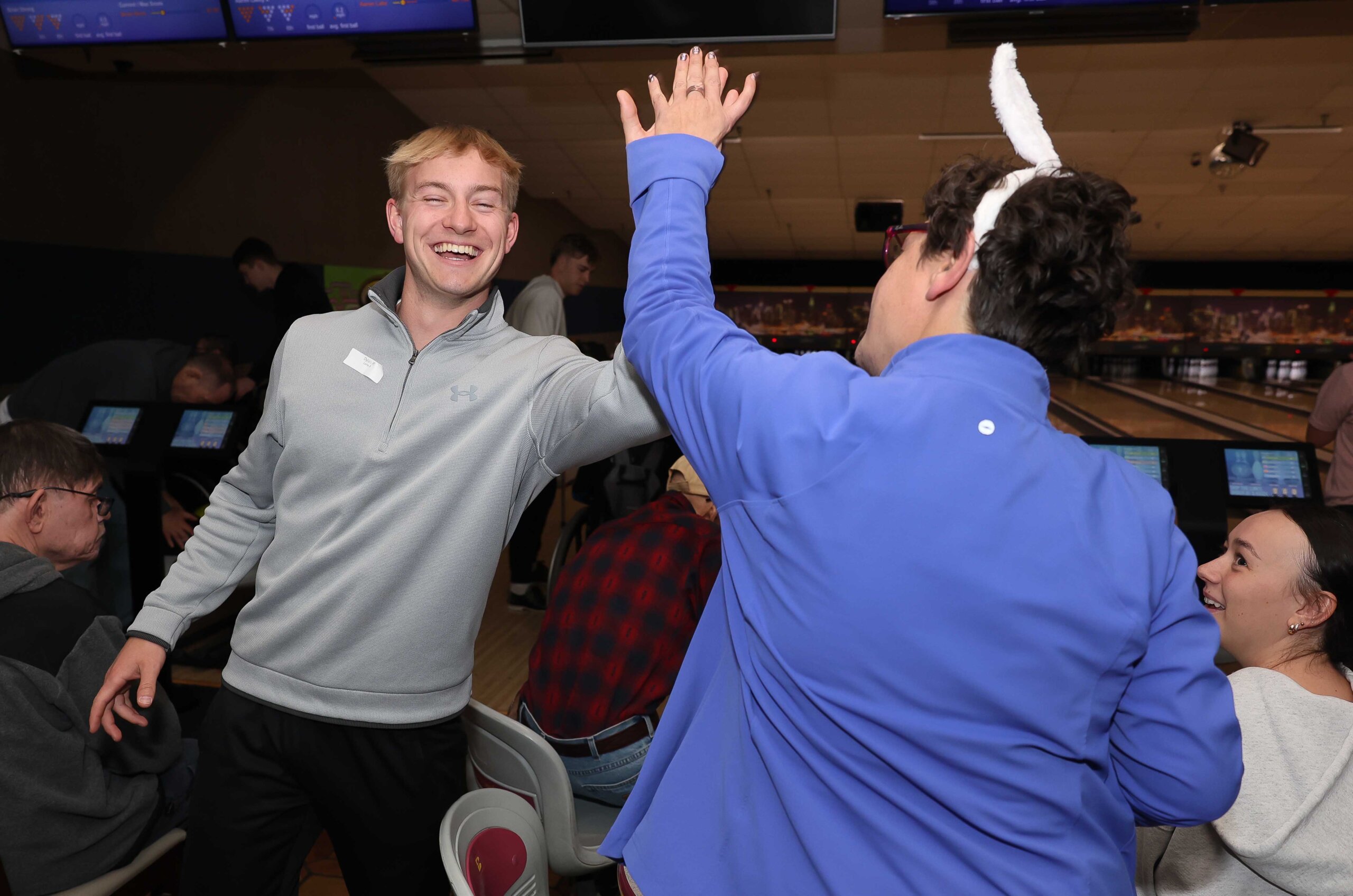 UNK junior Dylan Pfeifer high-fives a Buddy Bowling participant.