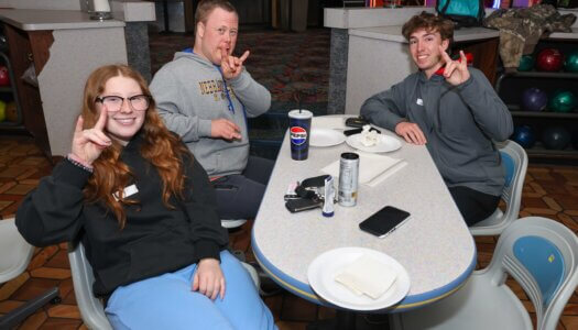 UNK students throw the lopes with a Buddy Bowling participant.