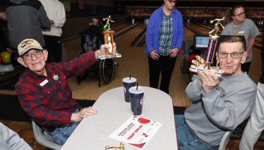 Buddy Bowling participants show off their trophies.