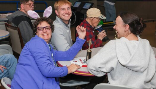UNK junior Dylan Pfeifer poses for a photo with a Buddy Bowling participant.