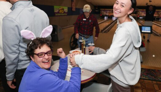 A UNK student and Buddy Bowling participant interact at Big Apple Fun Center.