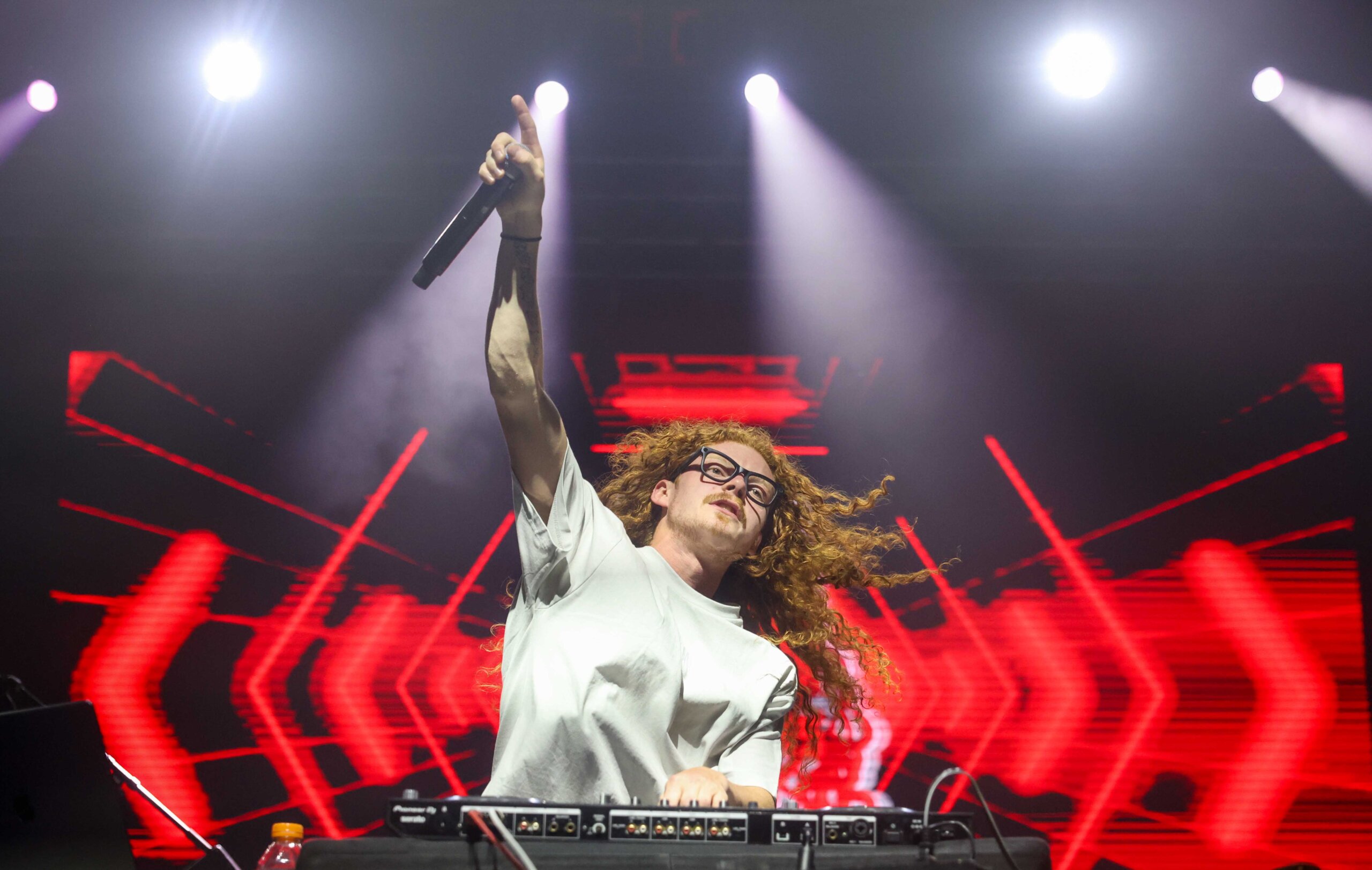 DJ Redlocks performs during the UNK spring concert.