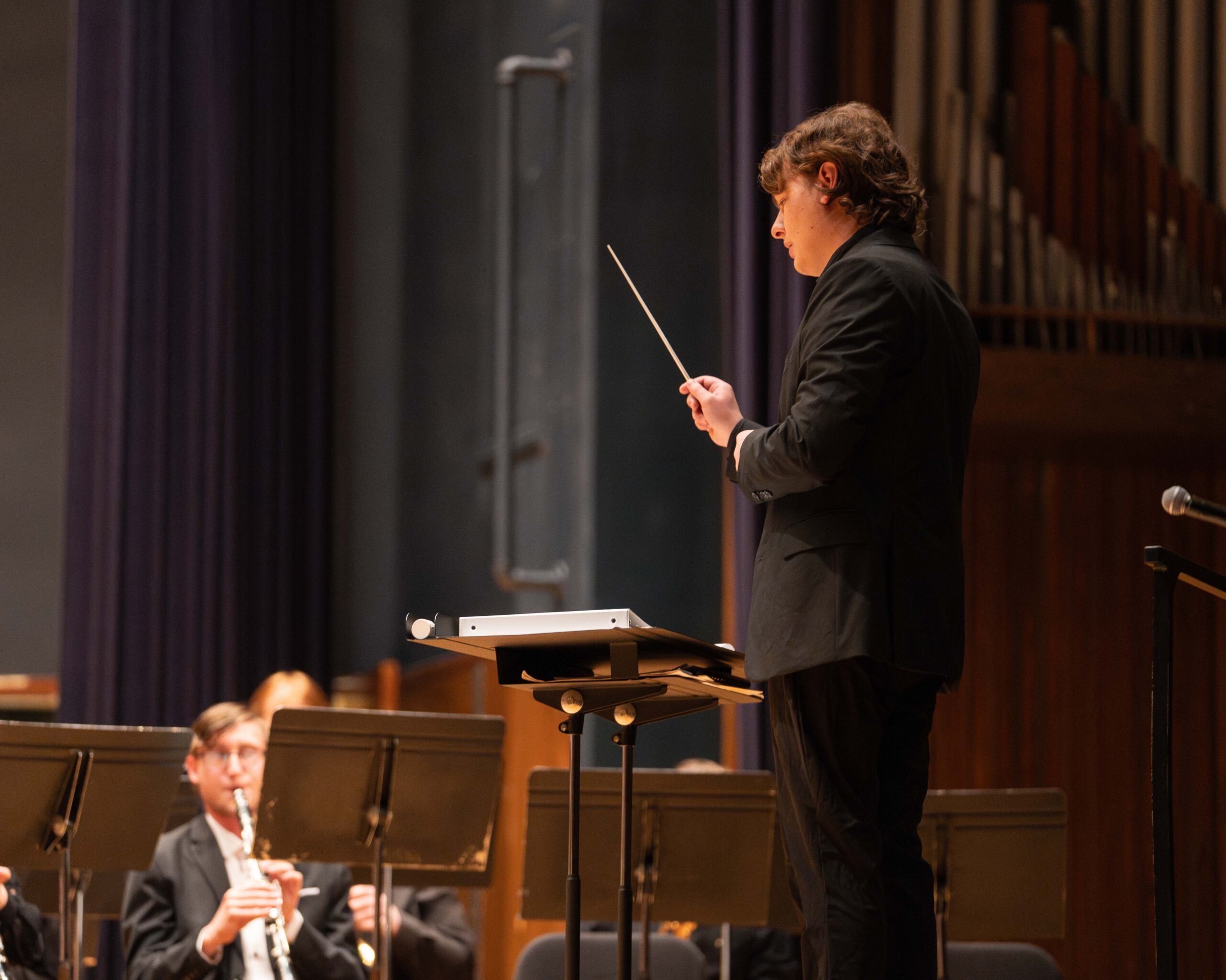 A student leads a piece at the Wind Ensemble and Symphonic Band joint concert Wednesday night.