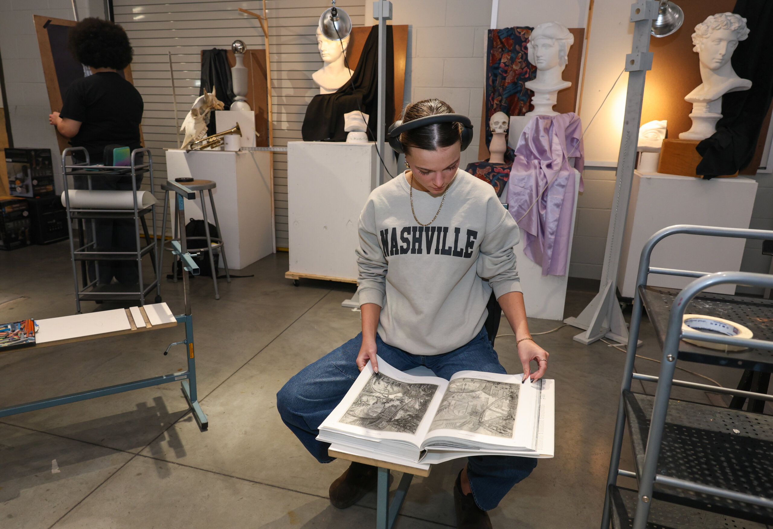 A student flips through an art book.