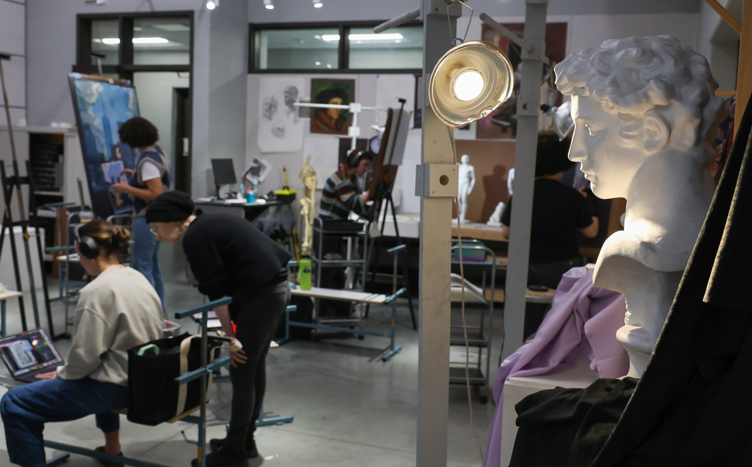 A sculpture is highlighted as students draw.
