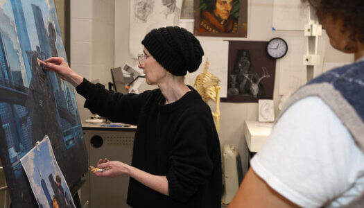 Printmaking and drawing professor demonstrates drawing to a student (Photo by Erika Pritchard, UNK Communications).