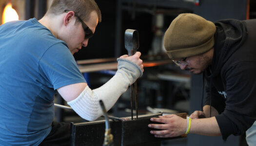 Students create glass pieces in the glassblowing studio (Photo by Erika Pritchard, UNK Communications).