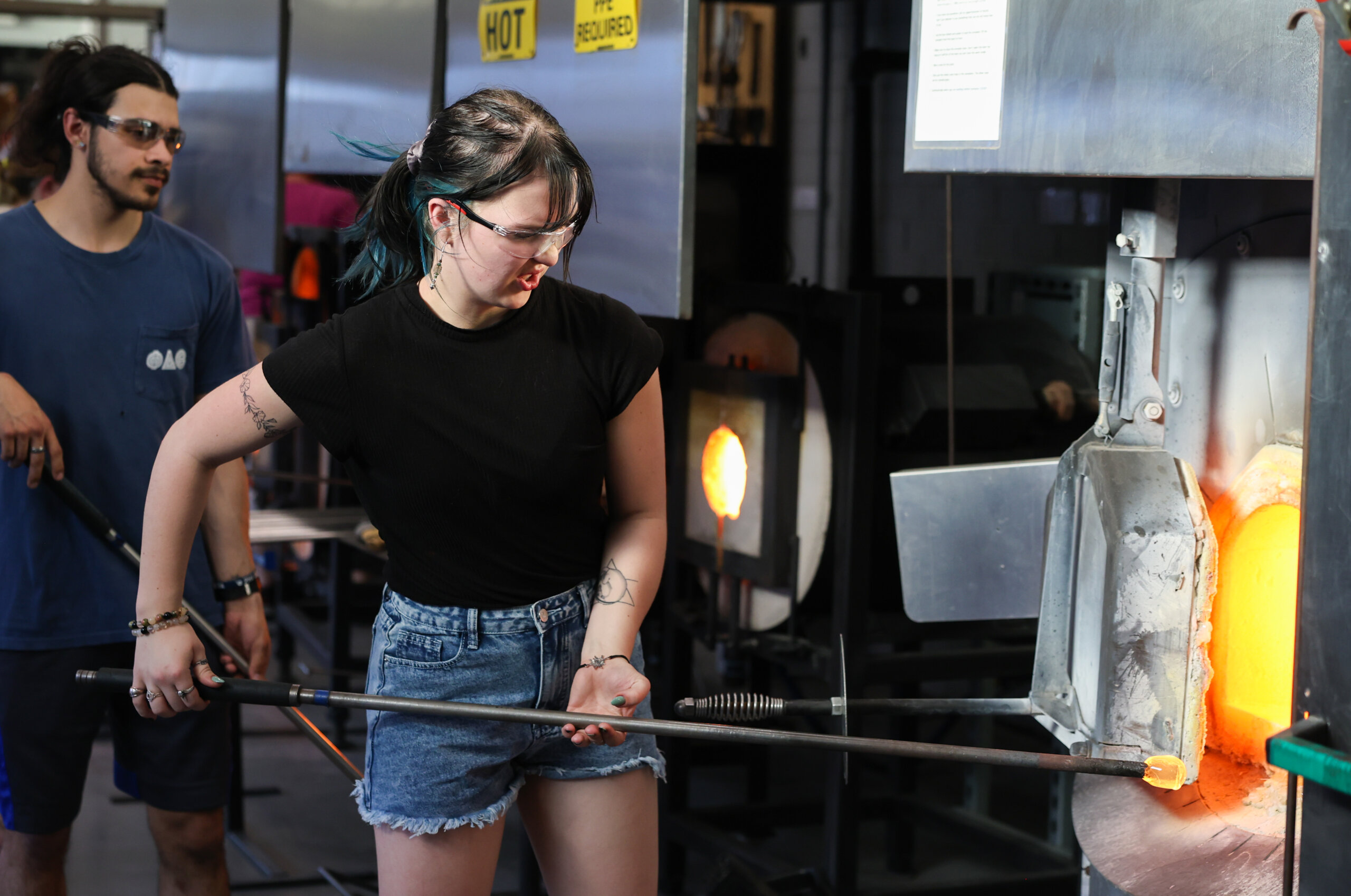 A student takes glass out of the fire.