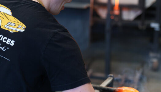 A student shapes glass in the glassblowing studio (Photo by Erika Pritchard, UNK Communications).