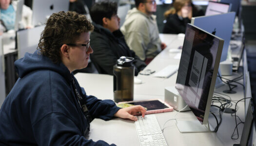 A student works on a computer in graphic design class (Photo by Erika Pritchard, UNK Communications).
