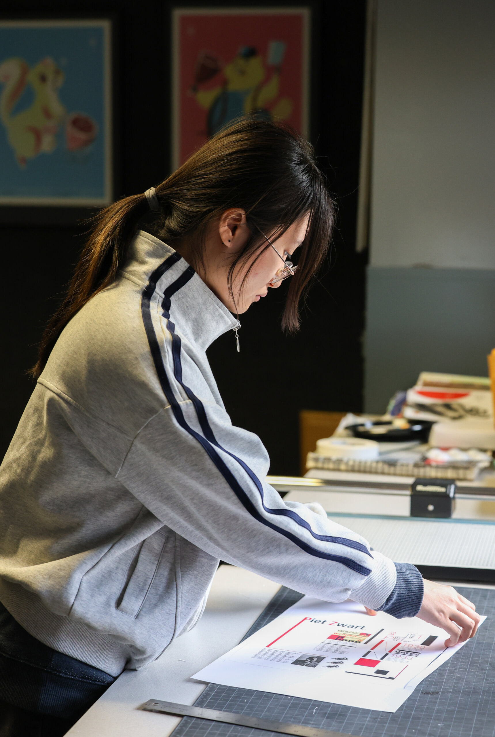 A student cuts paper.
