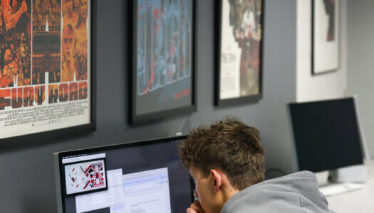 A student works on a computer in graphic design class (Photo by Erika Pritchard, UNK Communications).