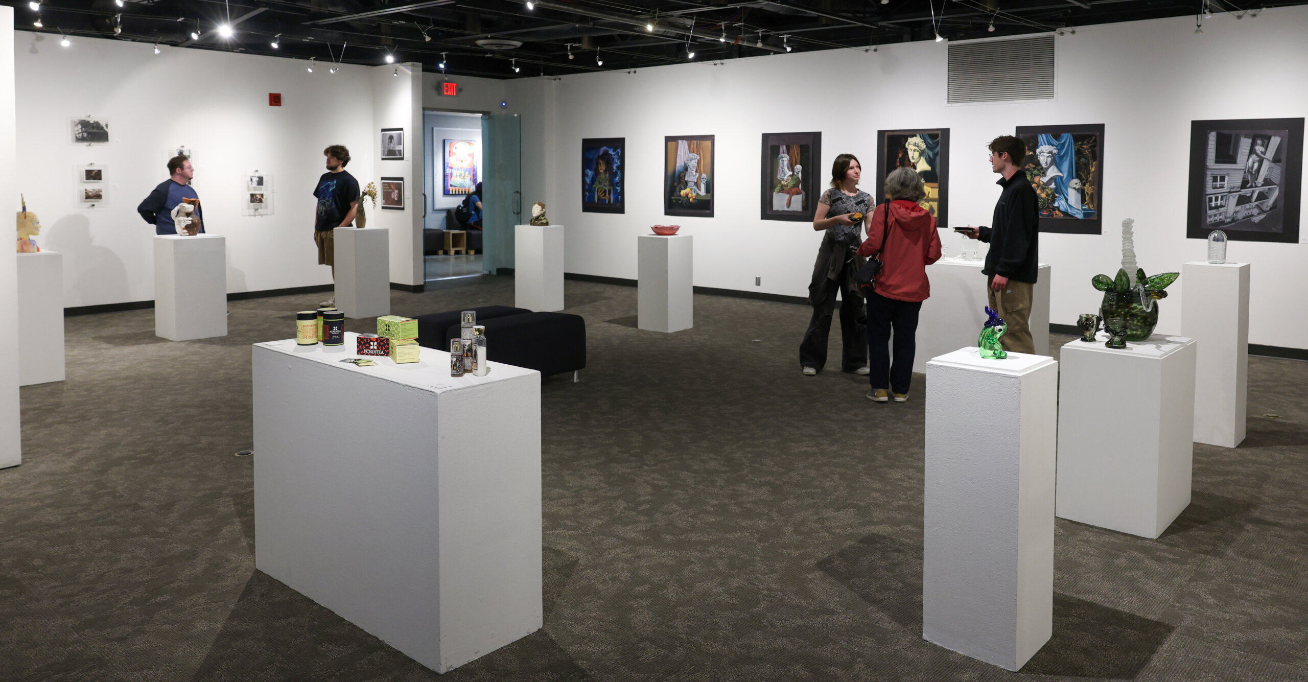 People stand in an art gallery.