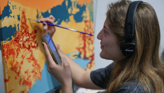 Maggie Waddington paints a landscape (Photo by Erika Pritchard, UNK Communications).