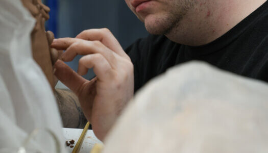 A student sculpts a piece in ceramics class (Photo by Erika Pritchard, UNK Communications).