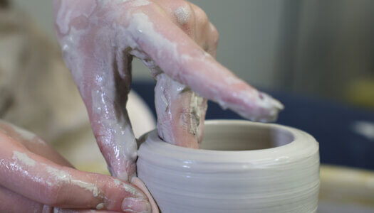 A student creates pottery in ceramics class (Photo by Erika Pritchard, UNK Communications).