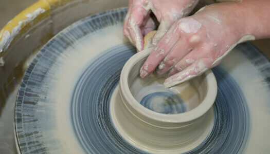 A student creates pottery in ceramics class (Photo by Erika Pritchard, UNK Communications).