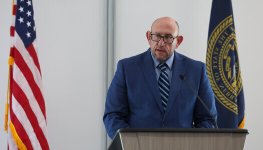 Associate Vice Chancellor of Student Affairs George Hollman speaks at the podium.