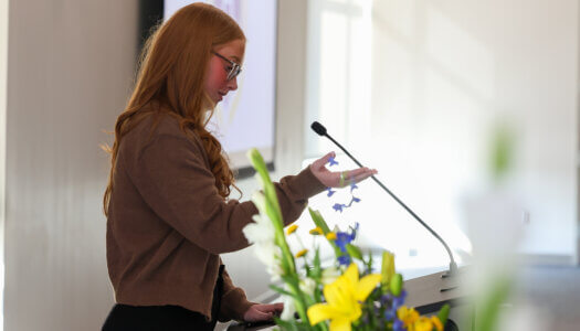 Jasmine Moats speaks at the podium.