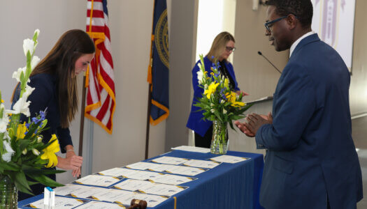 Wedly Martin receives a certificate for his service.