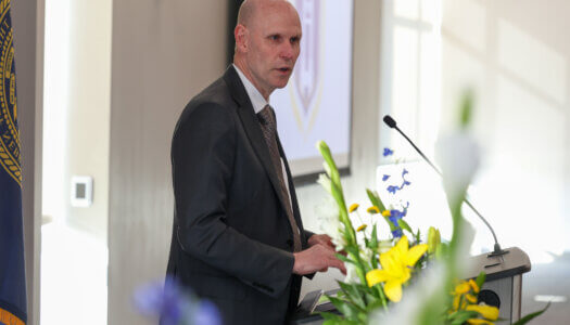 Chancellor Neal Schnoor speaks at the podium.