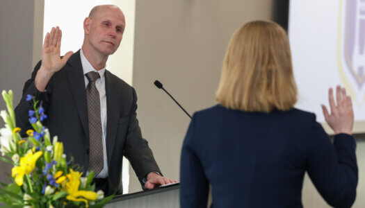 Chancellor Neal Schnoor swears in Paige Oltmans.