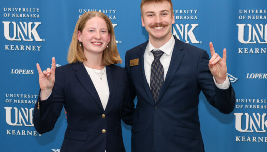Paige Oltmans and John Placke pose for a photo.