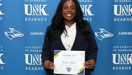 Godiva Kekeh poses with a certificate.