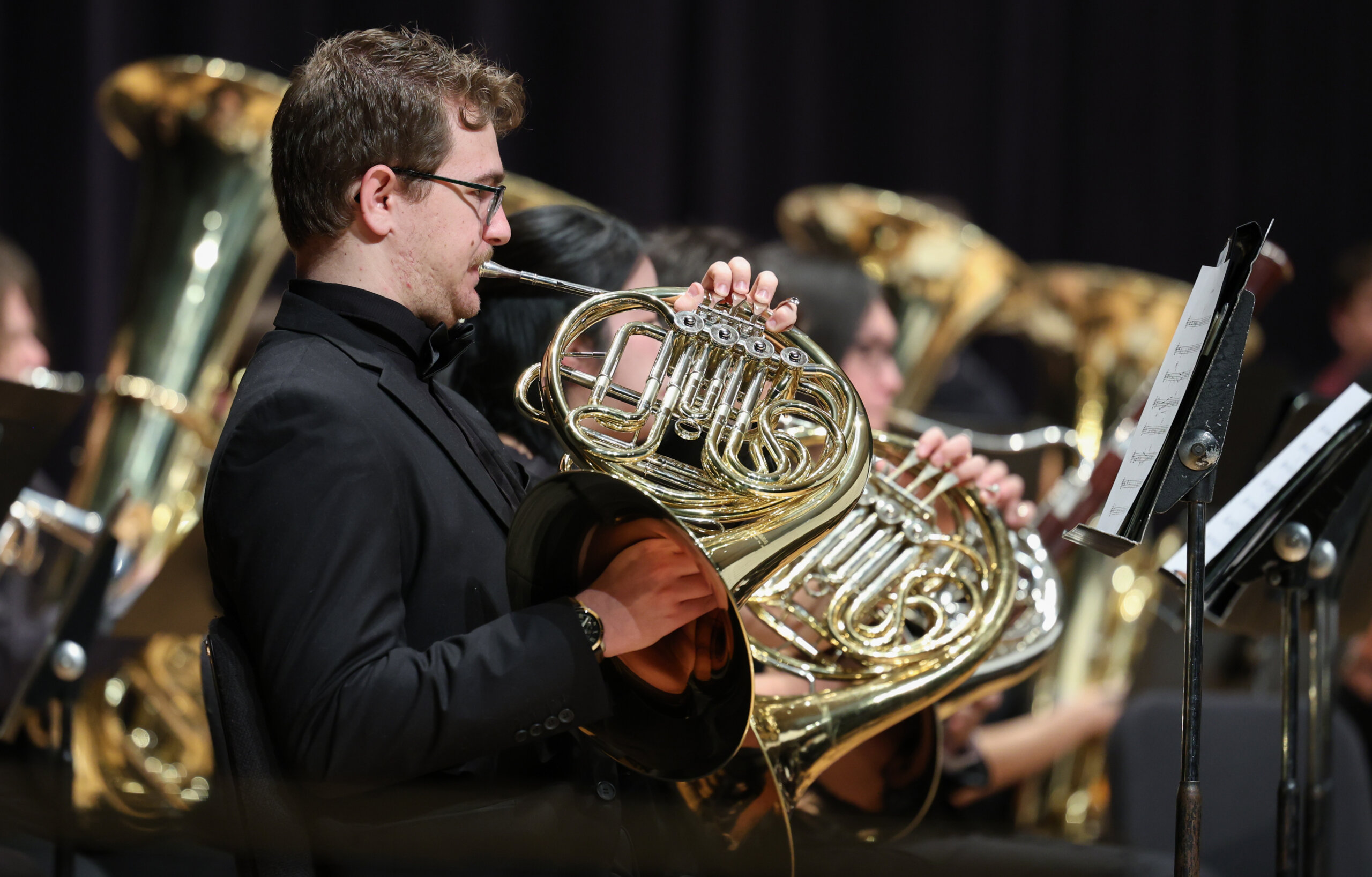 Students perform on musical instruments.