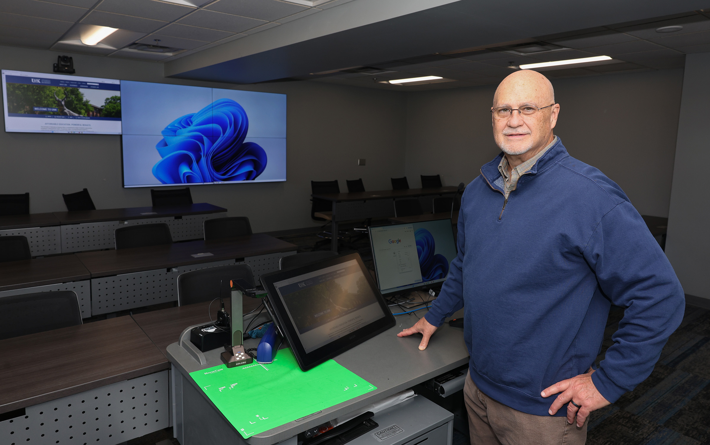 Tim Burkink poses for a photo in a classroom at UNK.